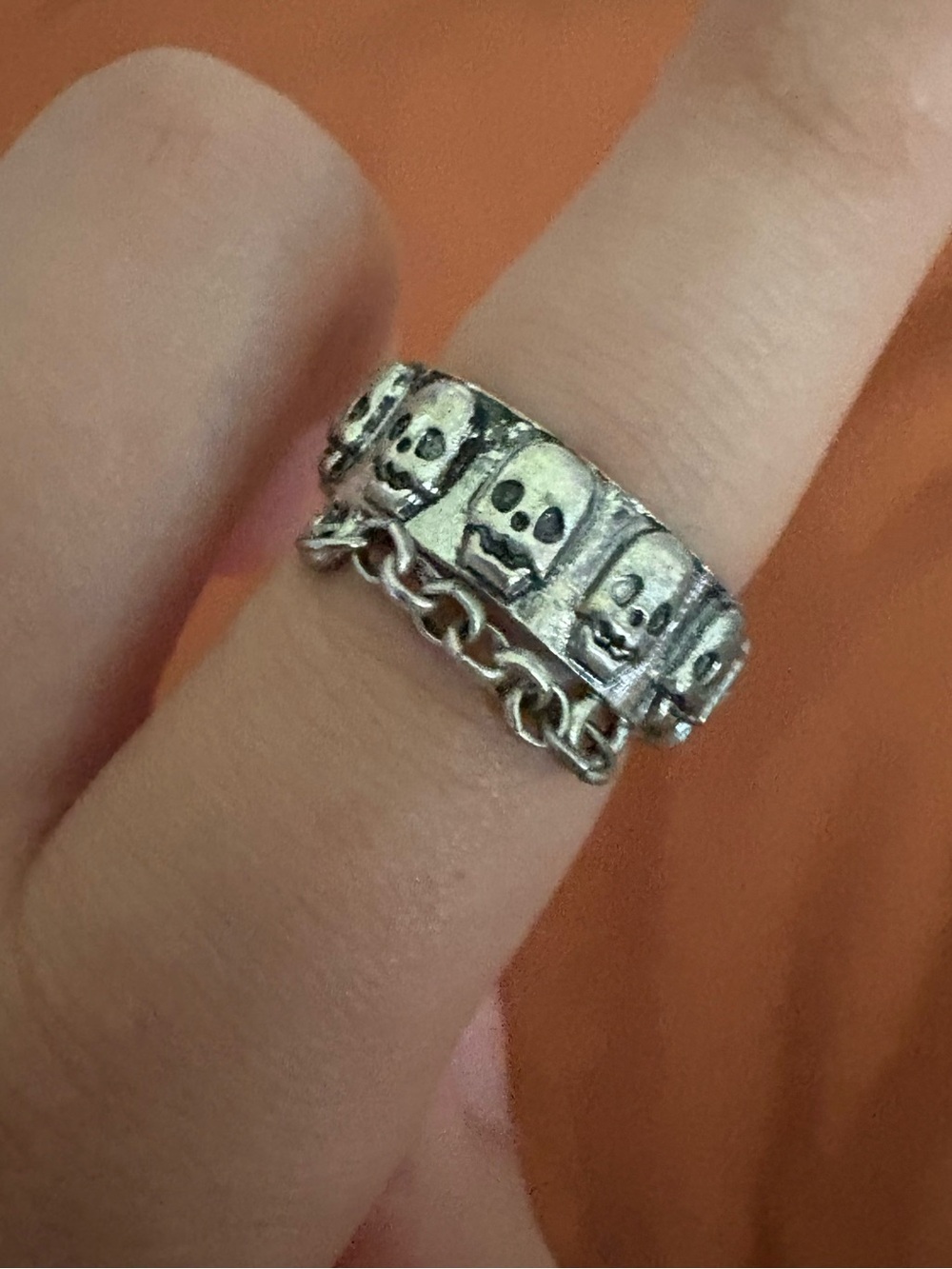 Silver ring w/ skulls and chain